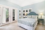 Guest room with a queen bed, twin bed, and a screen porch